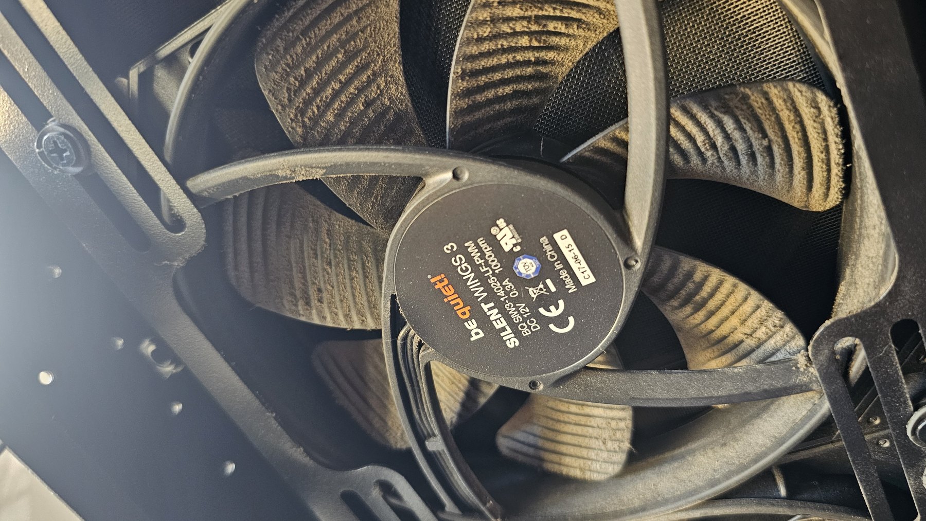 A dust-caked 140mm case fan