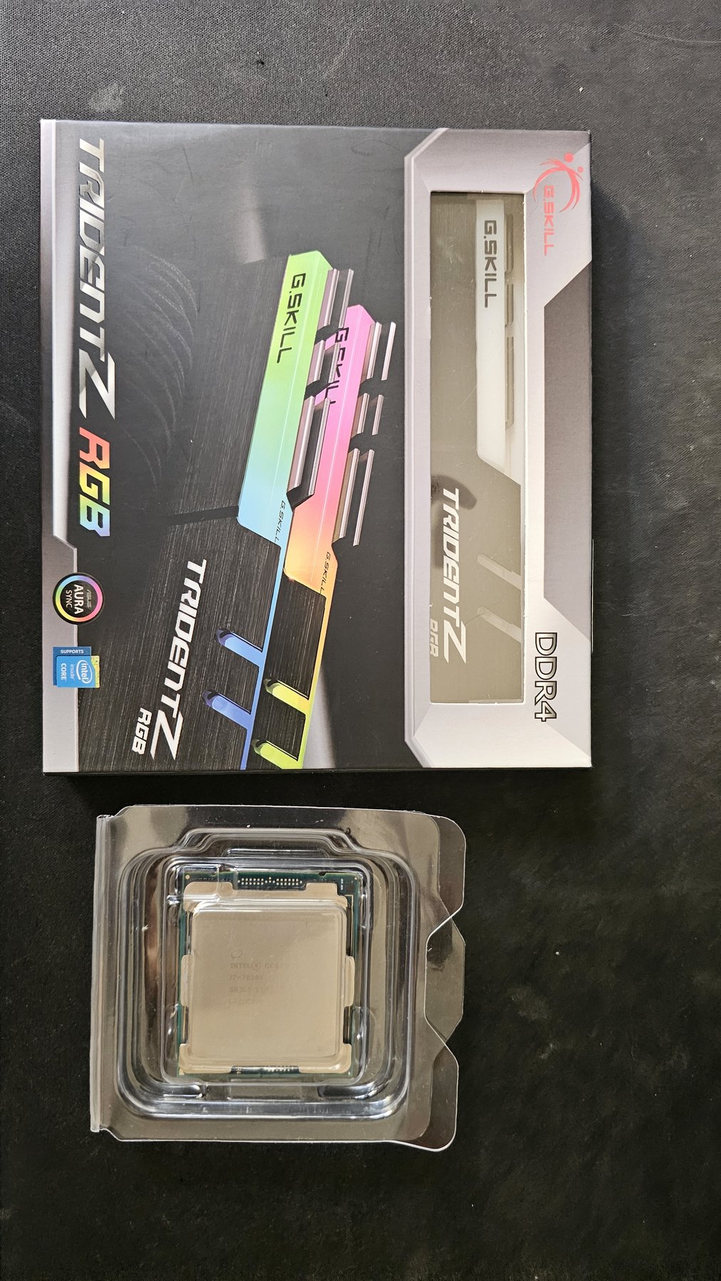 A G.SKILL Trident Z RGB DDR4 box next to a CPU in its plastic clamshell