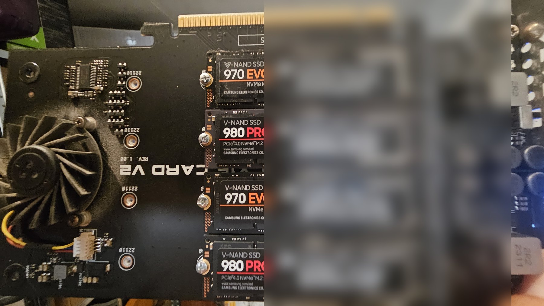 A PCIe carrier card populated with four Samsung NVMe SSDs, label area deliberately blurred
